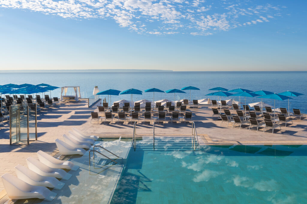 Outdoor pool with sun loungers and ocean view at Elba Sunset Mallorca Thalasso Spa Hotel