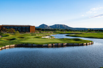 Lake with fairway and building in background at Emporda - Links Course