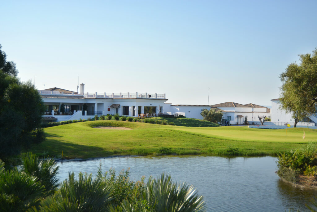 Lake with fairway and building in background at Fairplay Golf Club