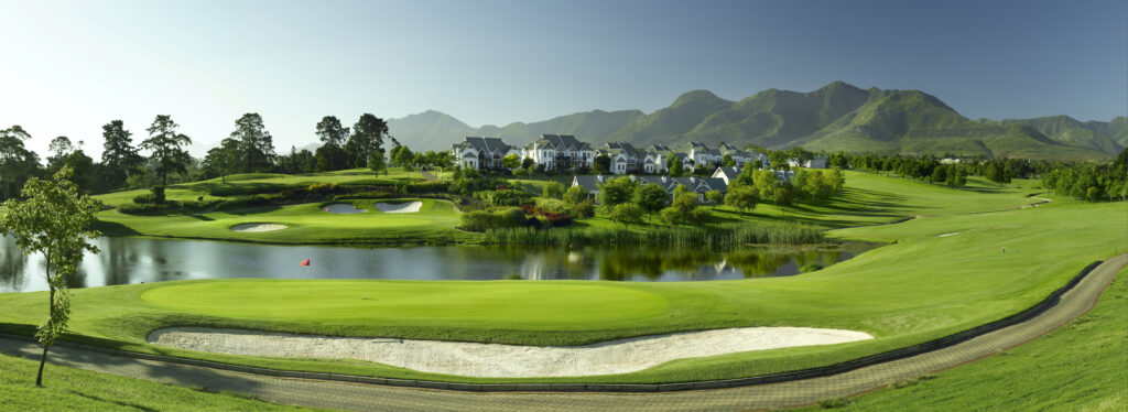 Hole with bunker at Fancourt - Montagu with lake and buildings in background