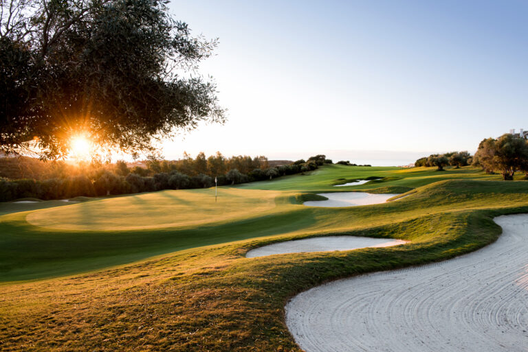 Hole with bunkers at sunset at Finca Cortesin Golf Course