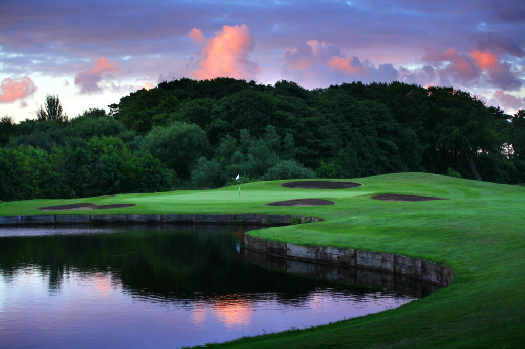 Lake and bunkers on fairway at sunset at Formby Hall Golf Resort & Spa