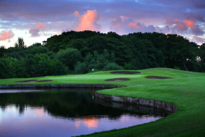 Lake and bunkers on fairway at sunset at Formby Hall Golf Resort & Spa