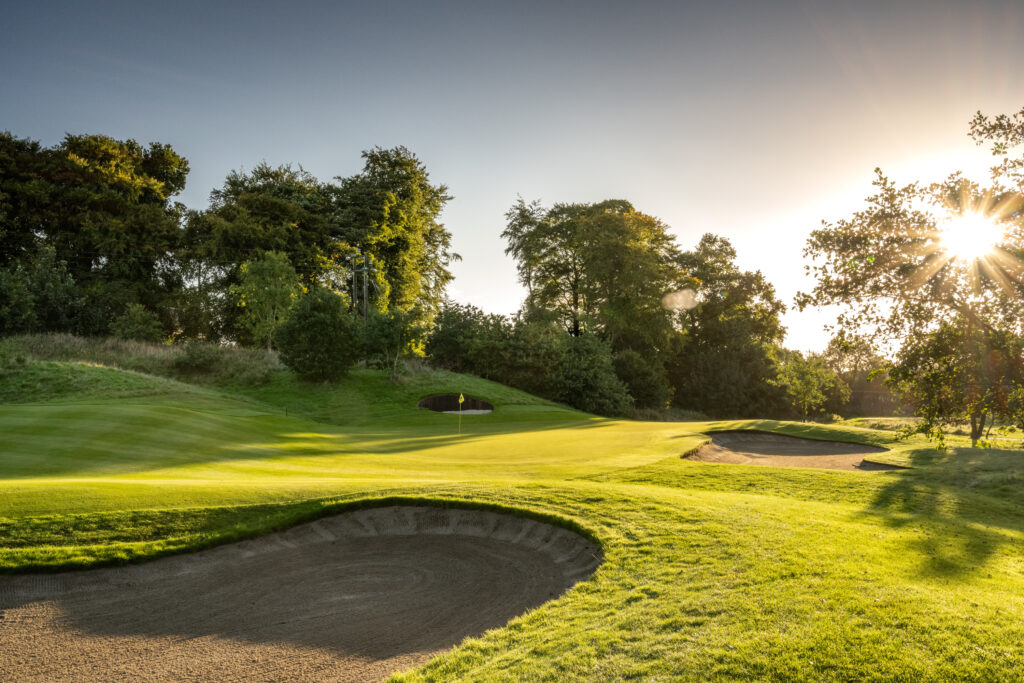 Hole with bunkres at Galgorm Championship Course with trees around