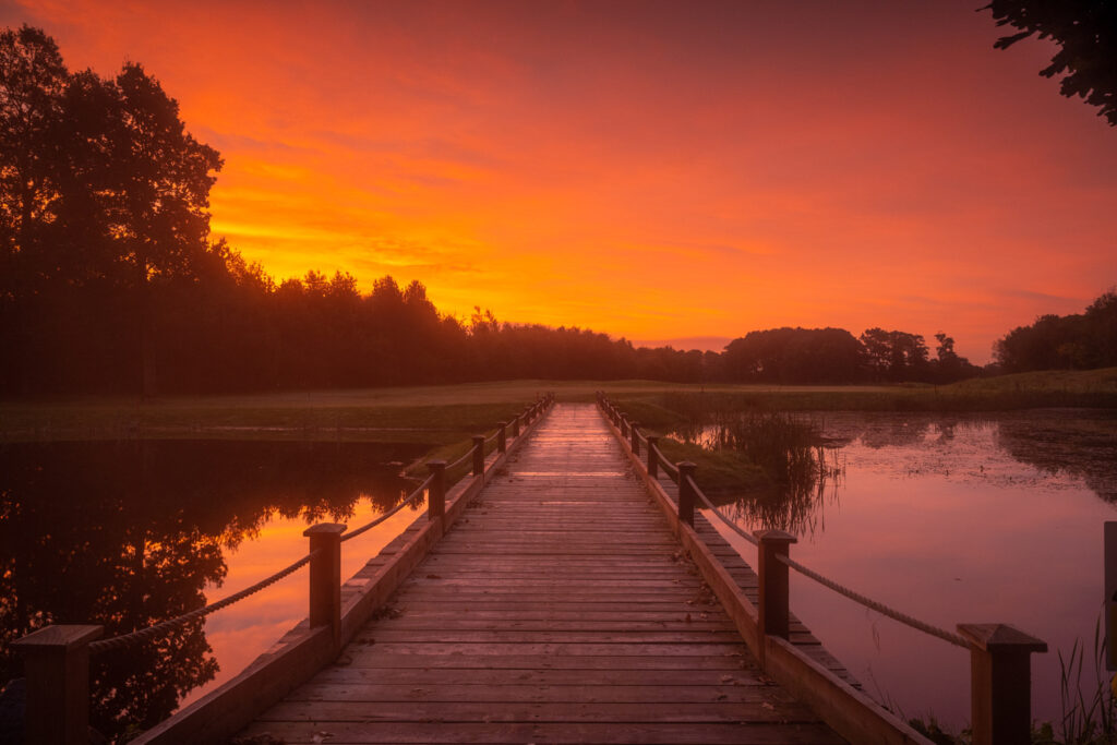 Bridge over lake at Galgorm Championship Course at sunset