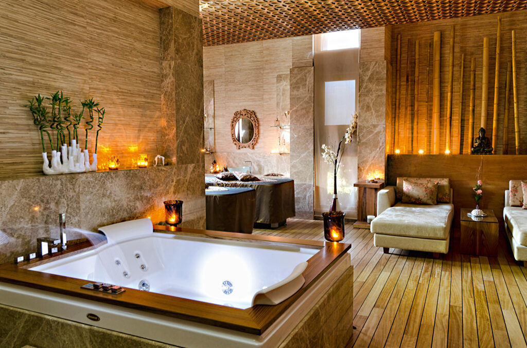 Treatment room within the spa at gloria golf resort, with treatment beds & jacuzzi bath