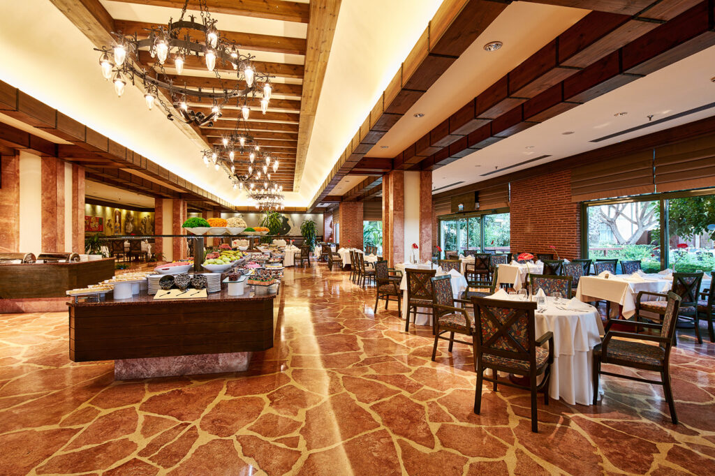 A large modern buffet restaurant within the Gloria Golf Resort complex. The food selection is plentiful with a plethora of seating available.