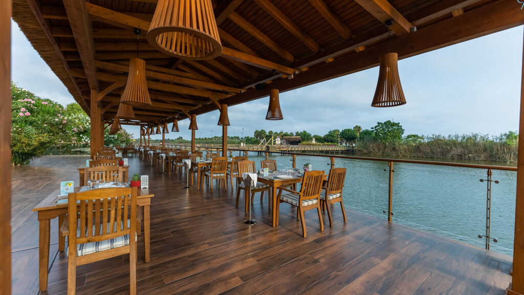 A beautiful outdoor restaurant that looks out over a flowing river.