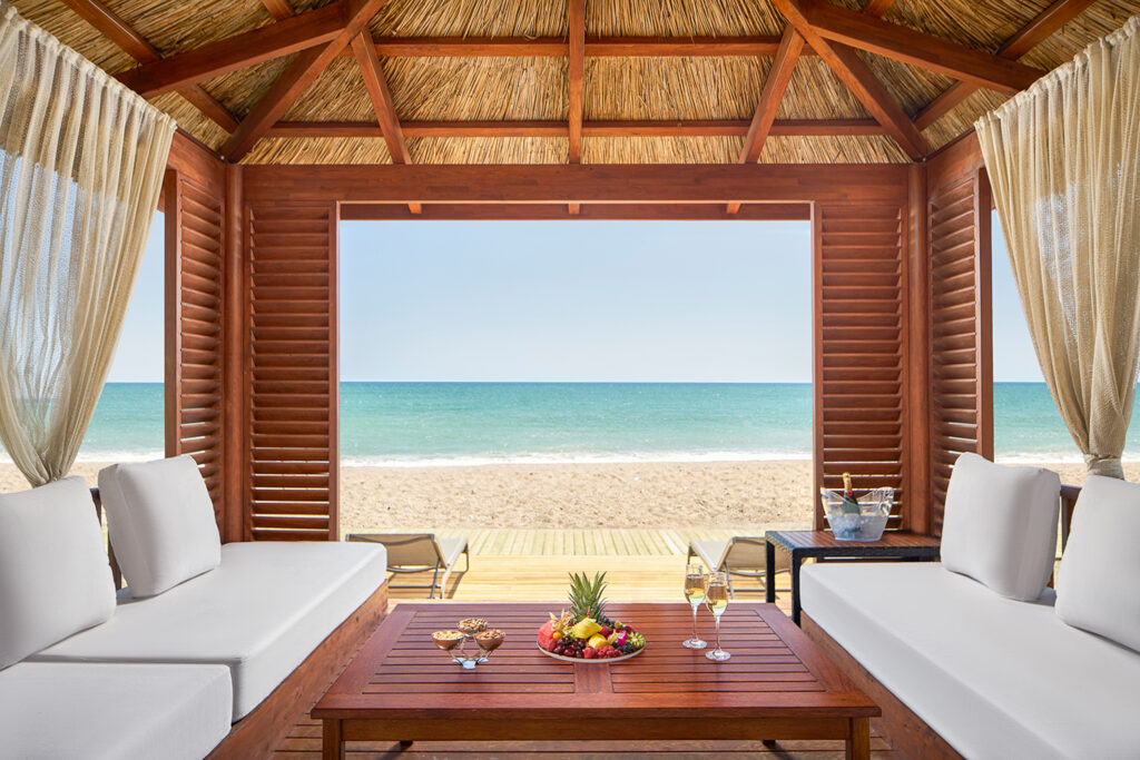 The pavillion beach huts at Gloria Serenity offer a luxury beach experience for guests looking to relax by the sea in the comfort of their own private space.