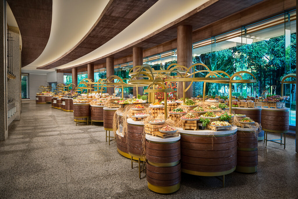 A view of the Tetrasomia main restaurant at the Gloria Serenity Golf Resort. This image shows a plethora of different stations of a variety of foods.