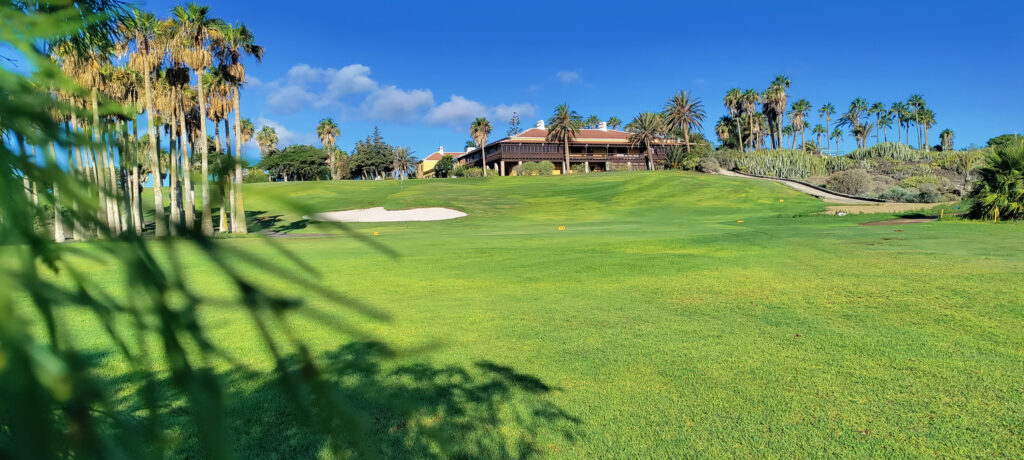 Fairway with trees and building in background at Golf del Sur