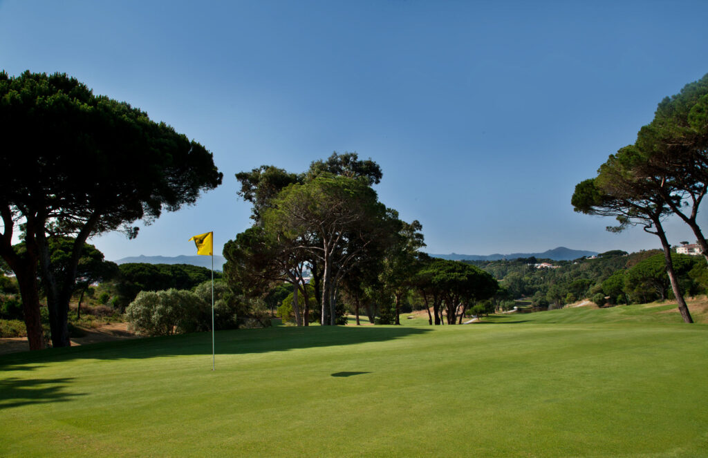 A hole with trees around at Golf do Estoril Golf Course