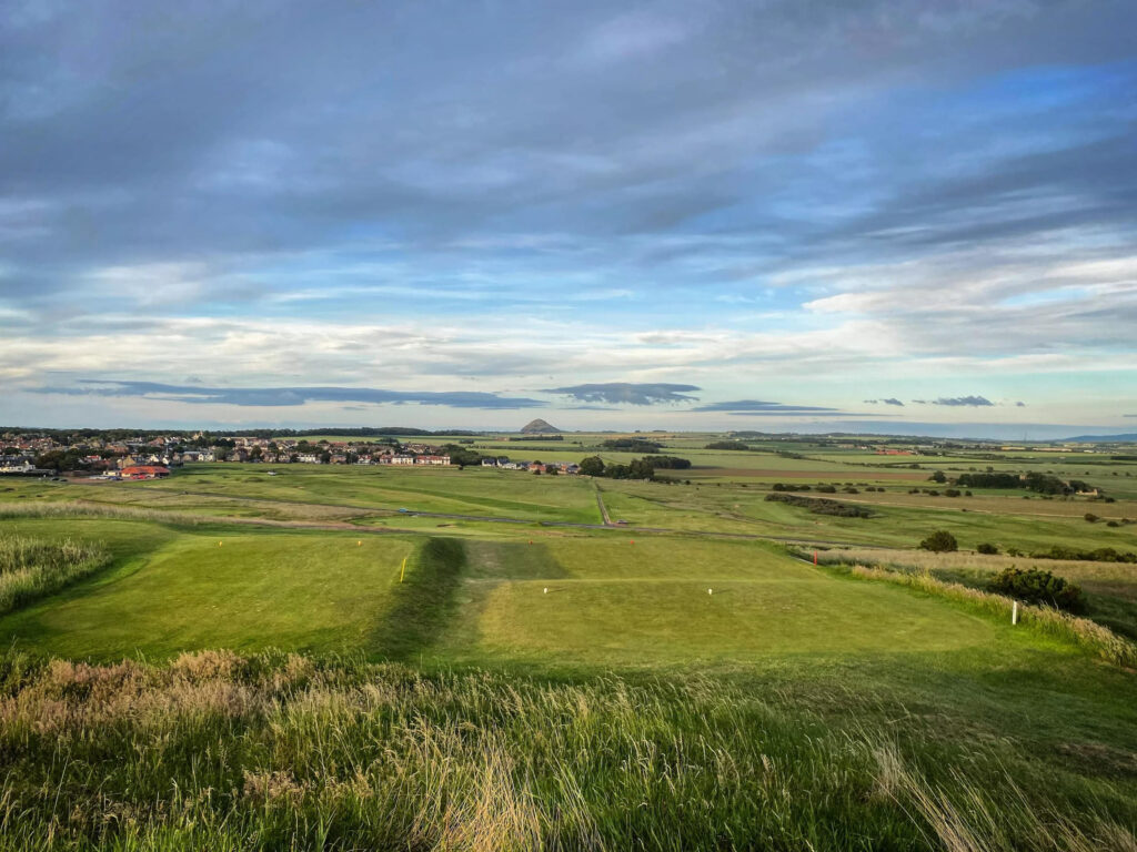 Tee box at Gullane Golf Club - No. 2 Course overlooking fairway and town in distance