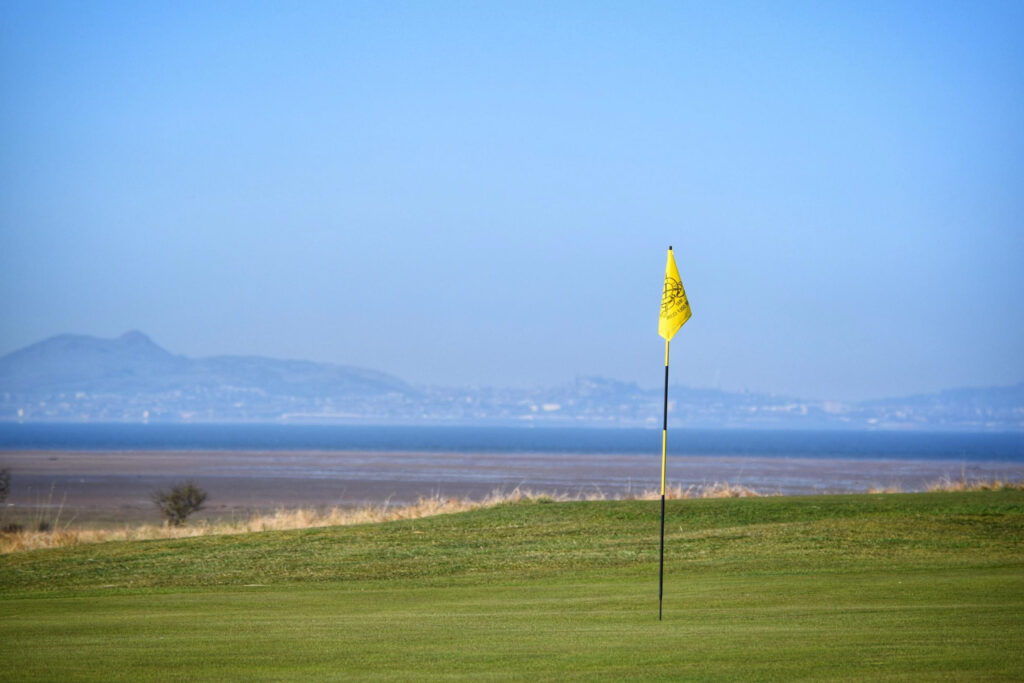 Yellow flag with ocean in background at