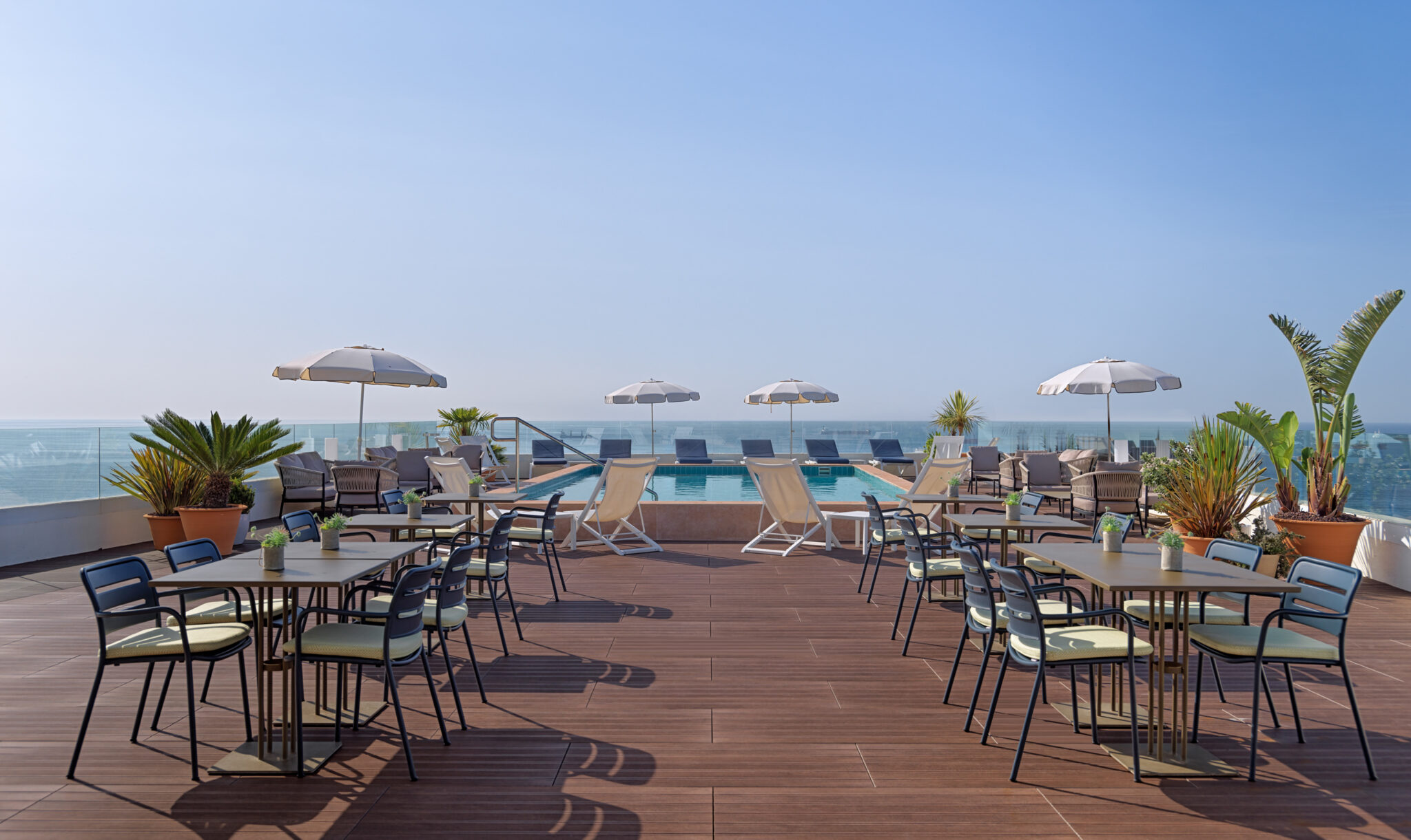 Outdoor pool with loungers at H10 Imperial Tarraco