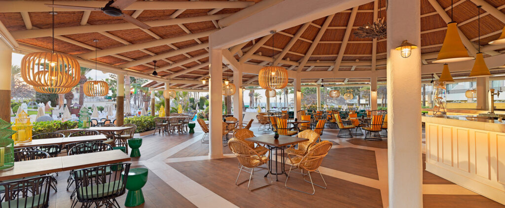 H10 Las Palmeras hotel outdoor seating area with bar