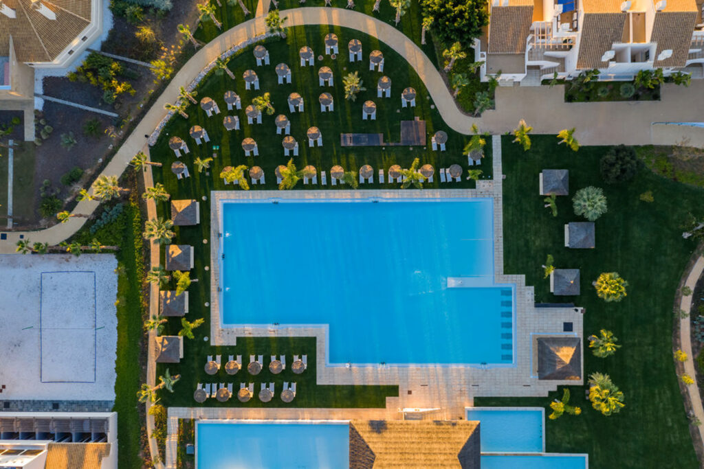 Birdseye view of the outdoor pool at Hacienda Del Alamo Golf Resort with loungers