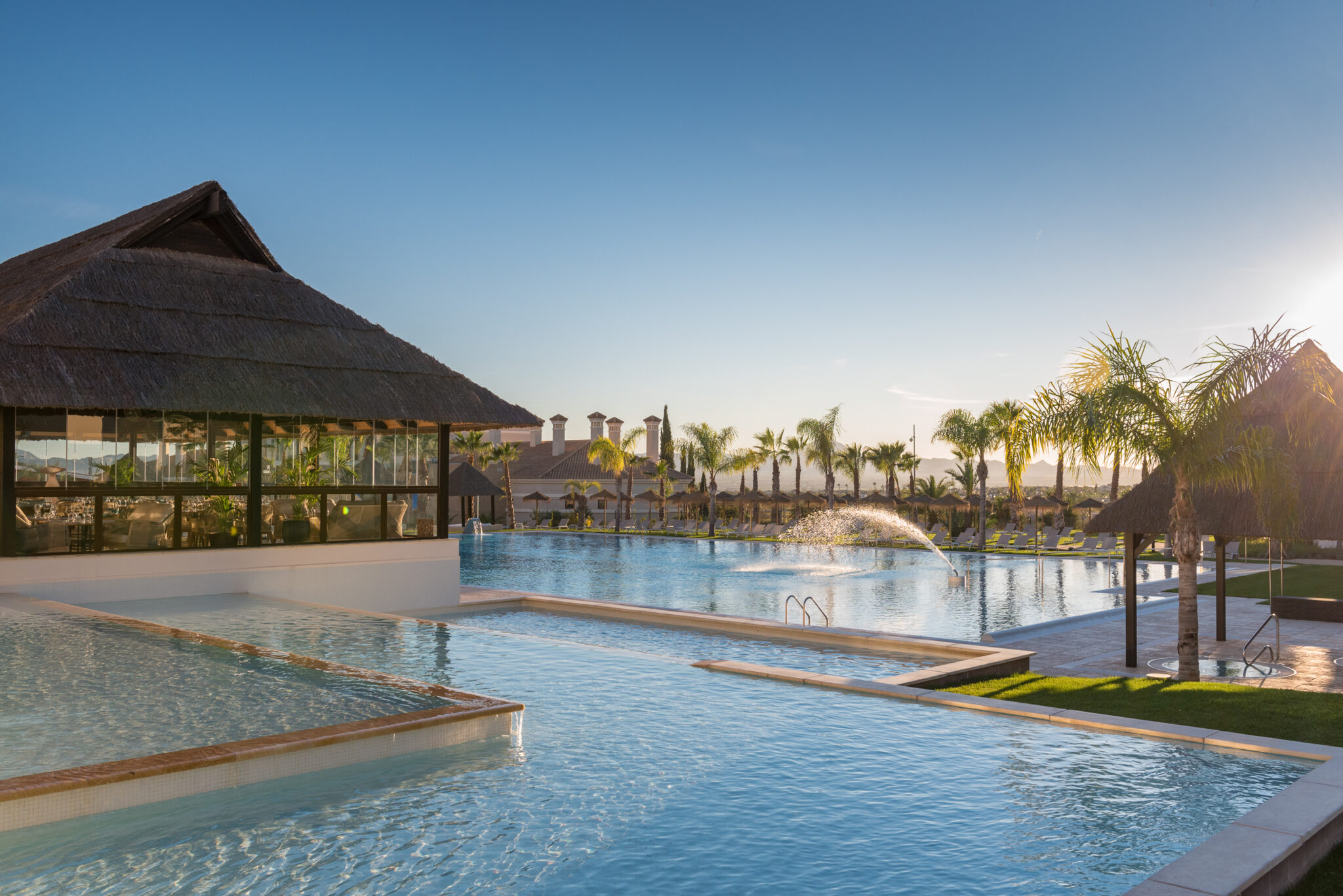 Outdoor pool at Hacienda Del Alamo Golf Resort with sprinkler