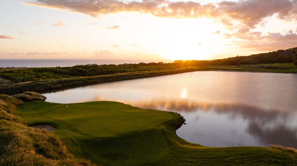 Hole with lake in background at Heritage Golf Club - La Reserve Golf Links at sunset