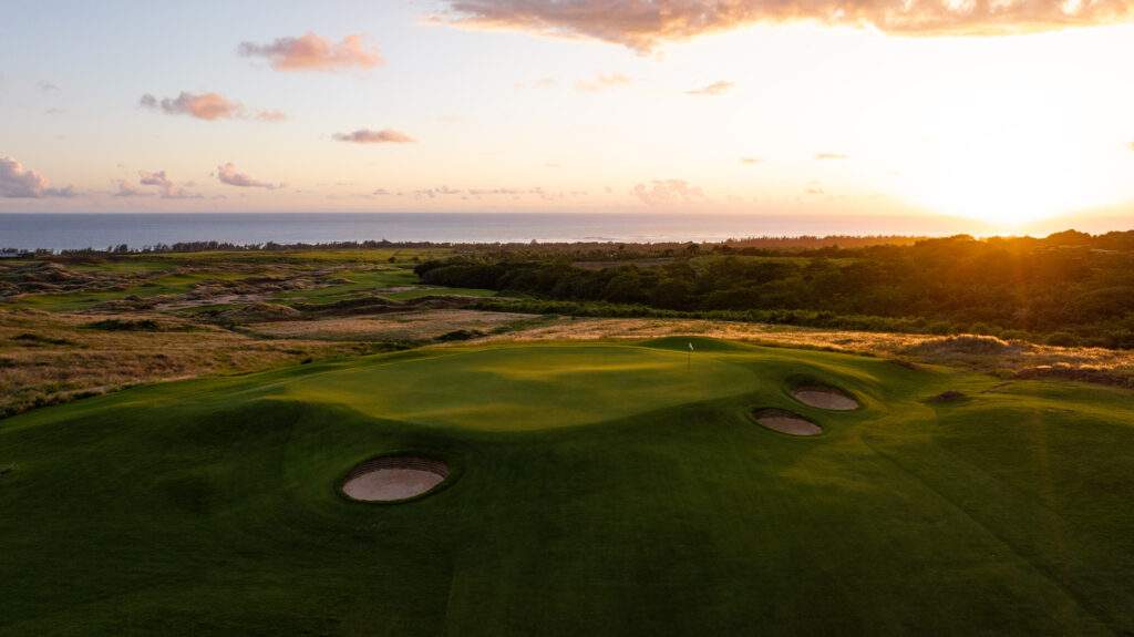 Hole with bunkers at Heritage Golf Club - La Reserve Golf Links with fairway in background at sunset