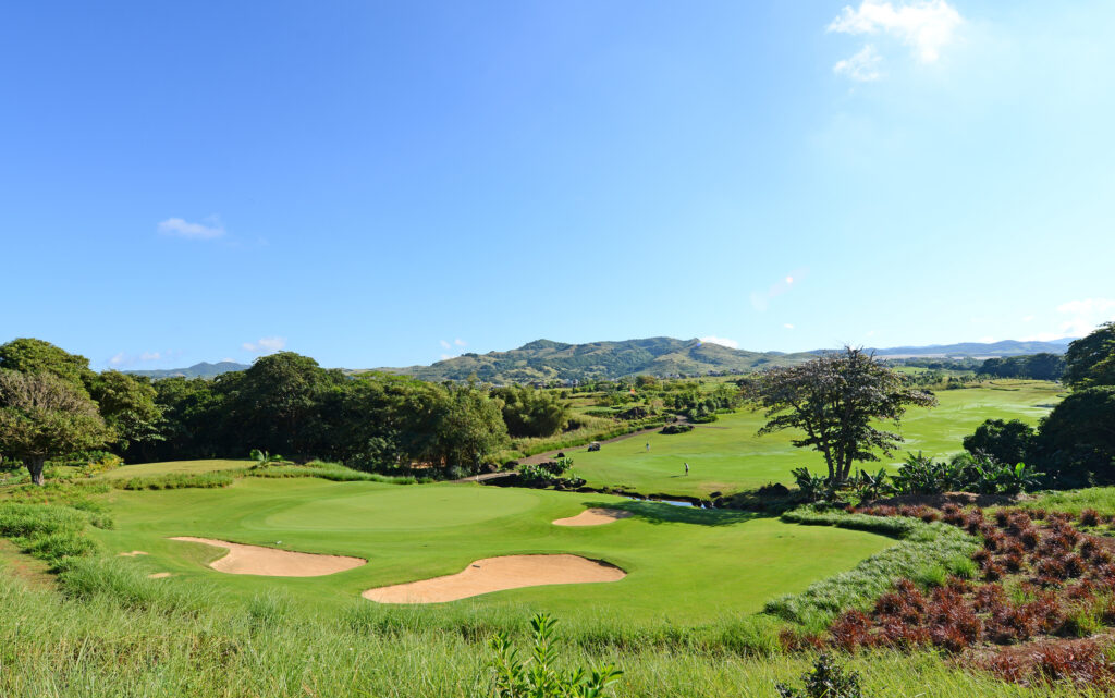 Hole with bunkers at Heritage Golf Club - Le Chateau Course with trees around and hills in distance