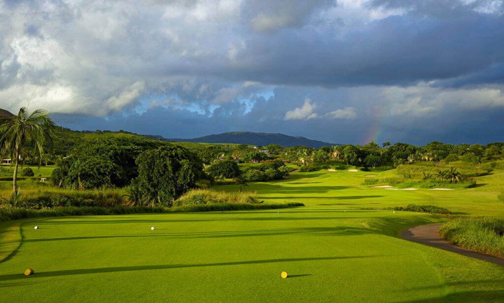 Tee box with trees around at Heritage Golf Club - Le Chateau Course with rainbow in distance