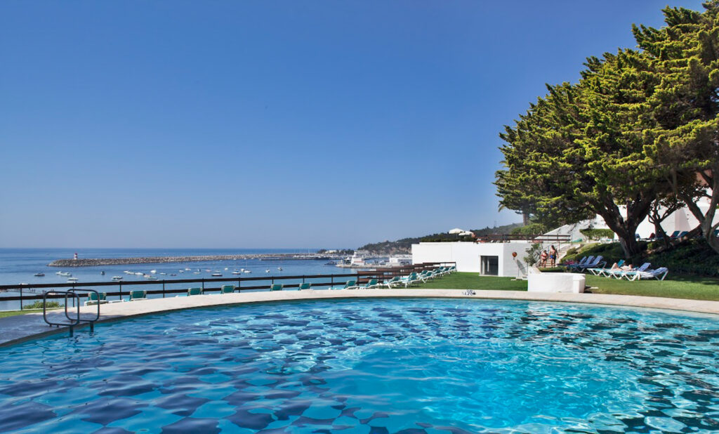 Outdoor pool with ocean view at Hotel do Mar