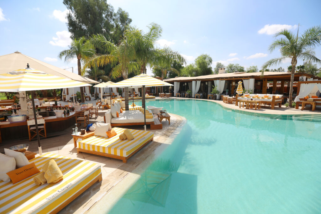 Outdoor pool at Hotel du Golf Rotana with sun beds