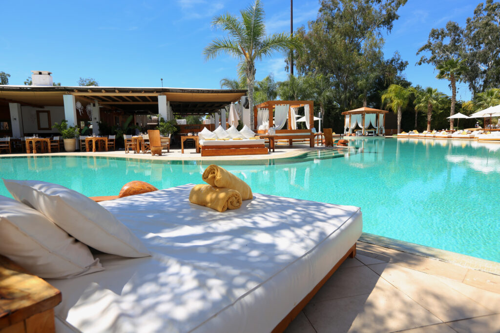 Outdoor pool with loungers at Hotel du Golf Rotana