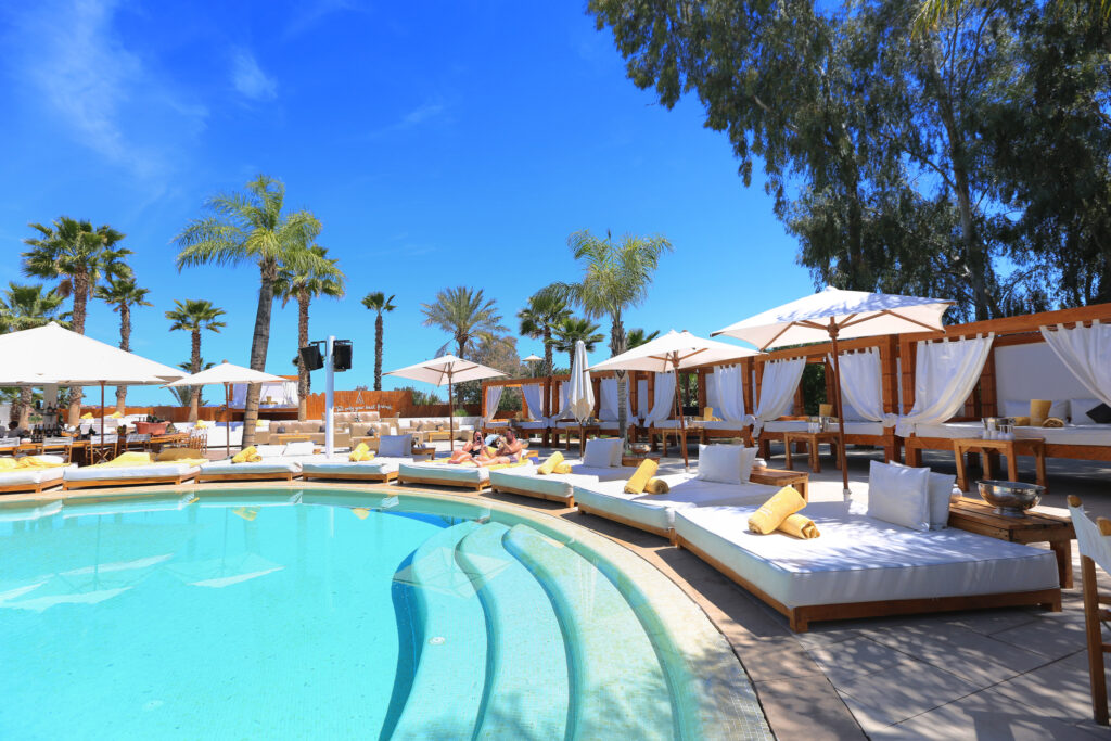 Outdoor pool at Hotel du Golf Rotana with sun beds