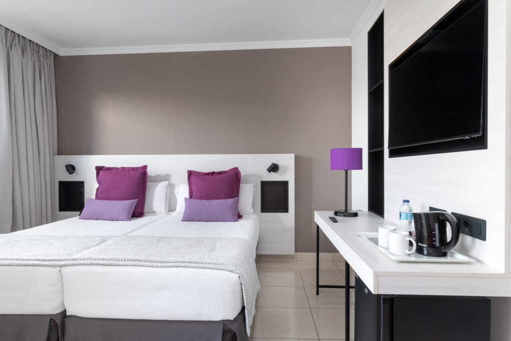 Hotel La Siesta bedroom with a television