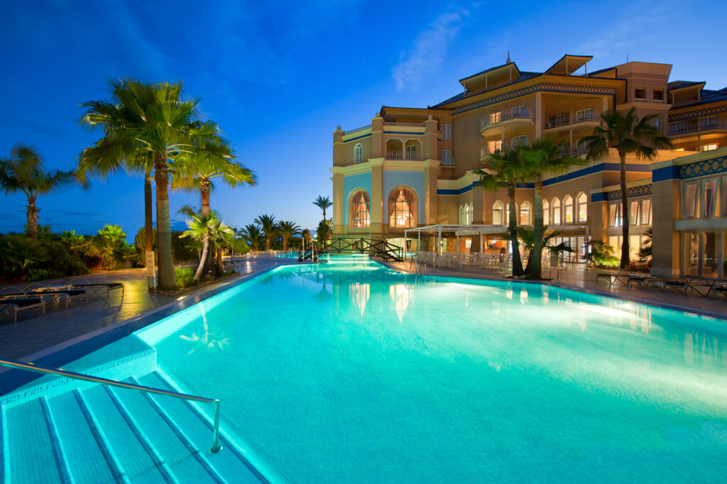 Outdoor pool and exterior of Hotel Melia Isla Canela at night