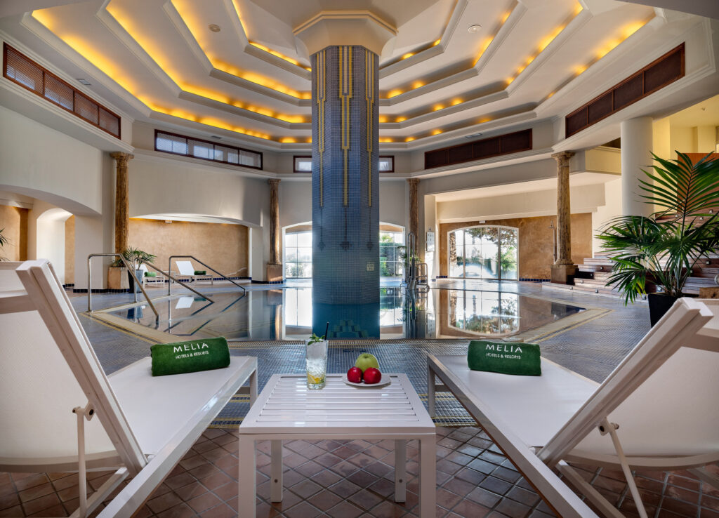 Indoor pool at Hotel Melia Isla Canela with loungers