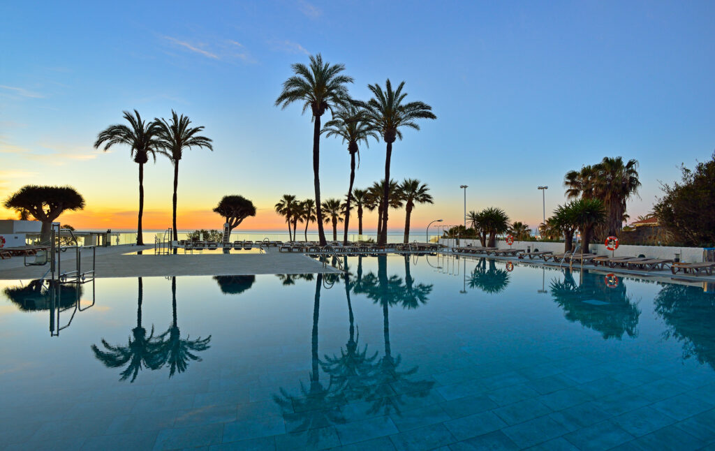 Outdoor pool at Hotel Ocean House Costa Del Sol at sunset