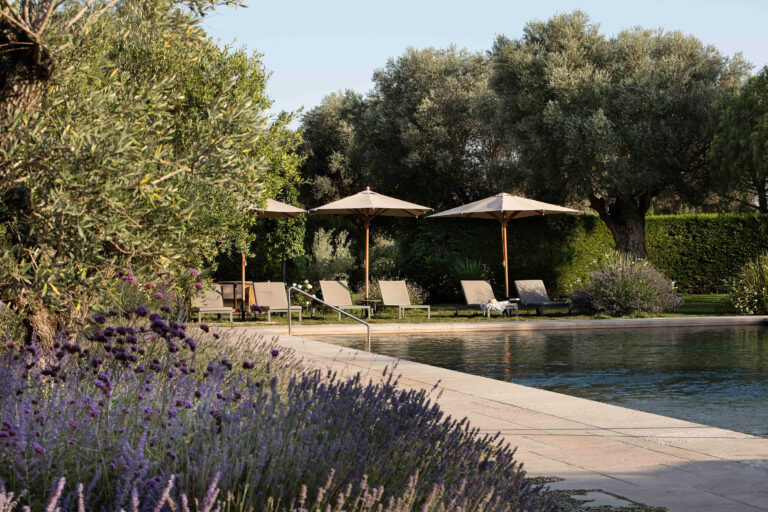 Outdoor pool with sun loungers at Hotel Peralada