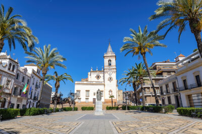picture of a square with a church and tower in Huelva
