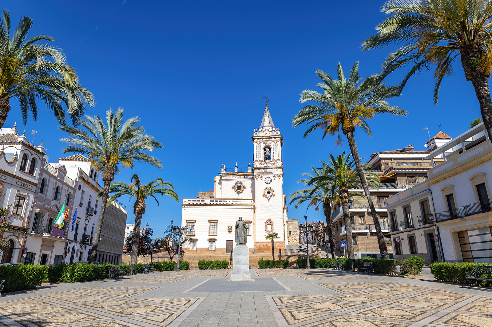 picture of a square with a church and tower in Huelva