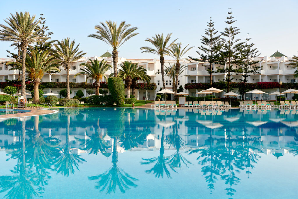 Outdoor pool at Iberostar Founty Beach Hotel with loungers and palm trees