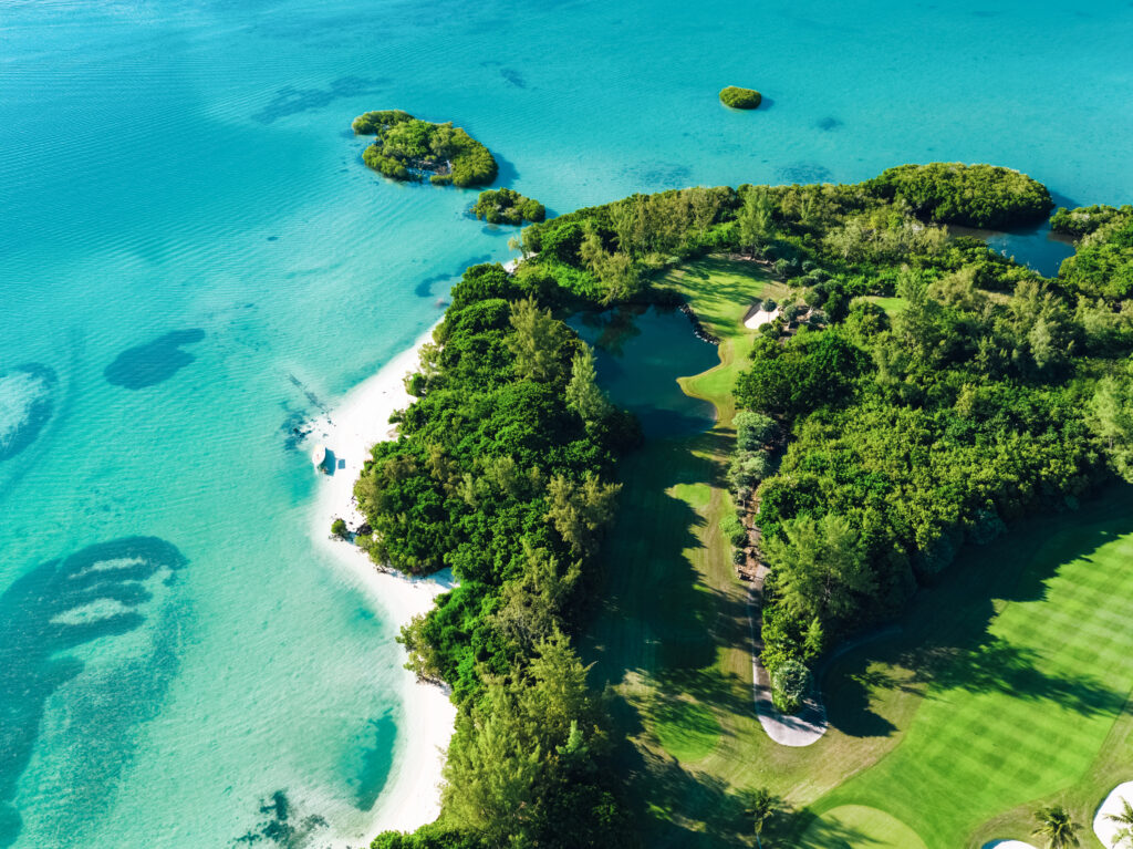 Aerial view of Ile Aux Cerfs Golf Club with ocean surrounding and trees around