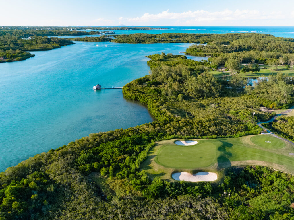 Aerial view of Ile Aux Cerfs Golf Club with ocean in background and trees around