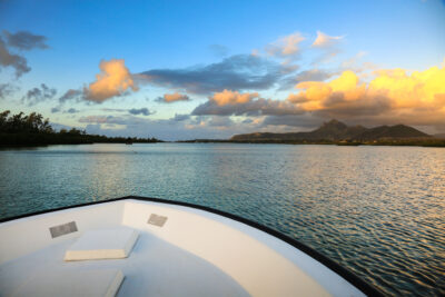 View of ocean from a boat at Ile Aux Cerfs Golf Club with hills in distance