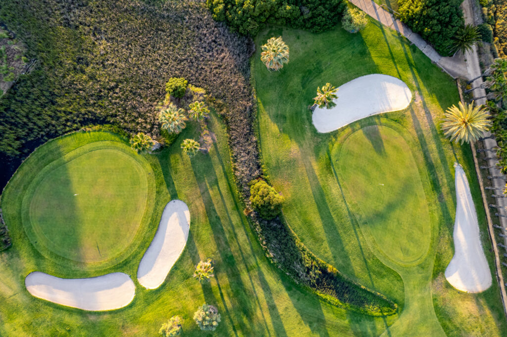 Aerial view of two holes at The Isla Canela Old Course