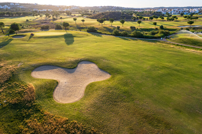 Bunker on fairway with trees around at Isla Canela Links