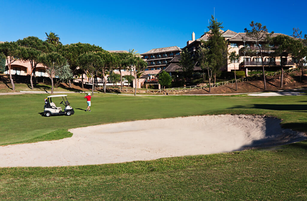 Person playing at Islantilla Golf Course with buggy