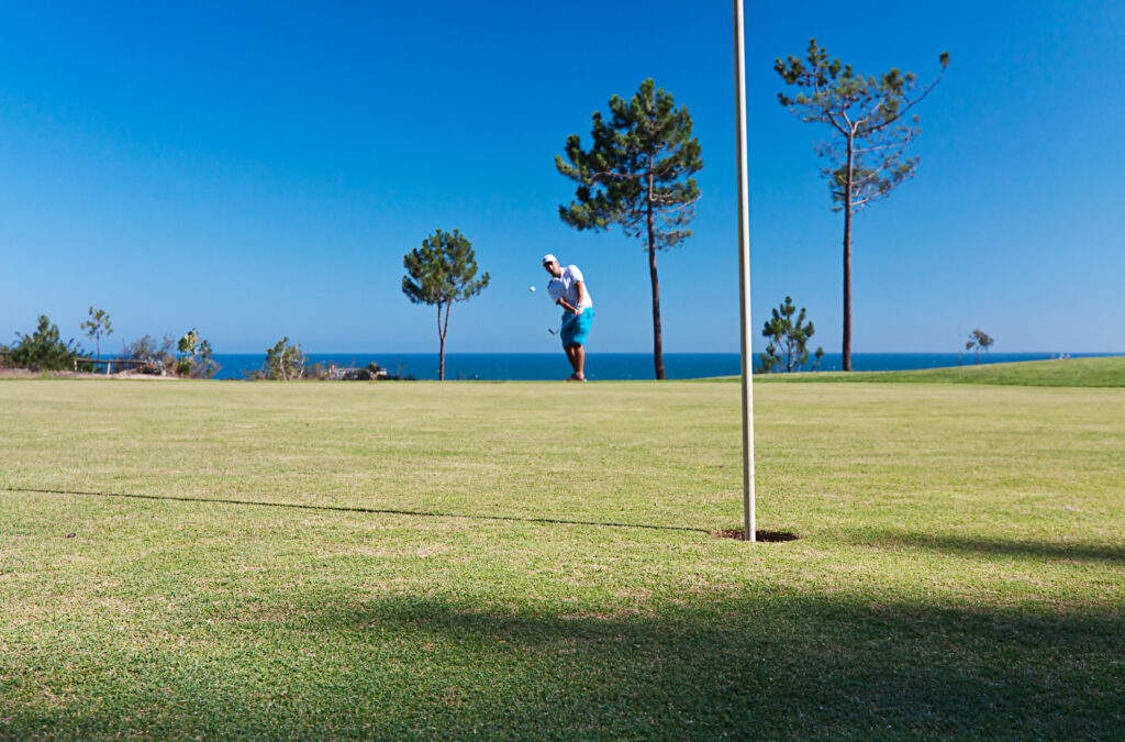 Person playing golf on a green at Islantilla Golf Course