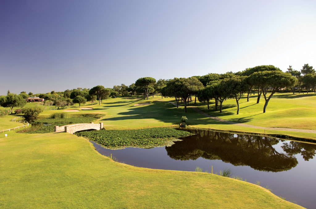 Fairway with lake and trees around at Pinheiros Altos Golf Course