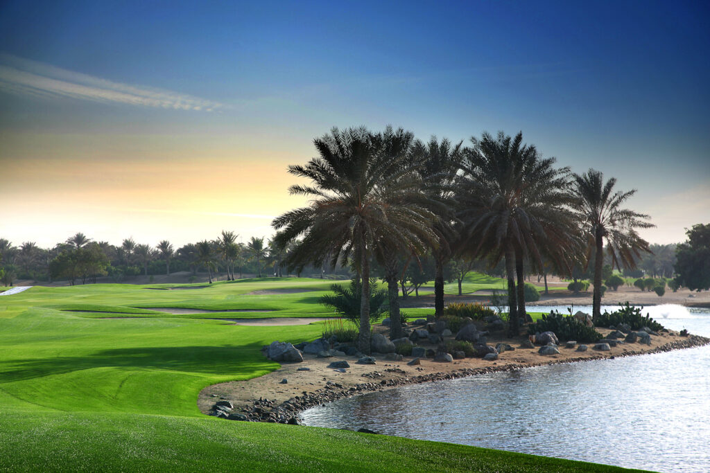 Fairway at Abu Dhabi Golf Club - National with lake and palm trees