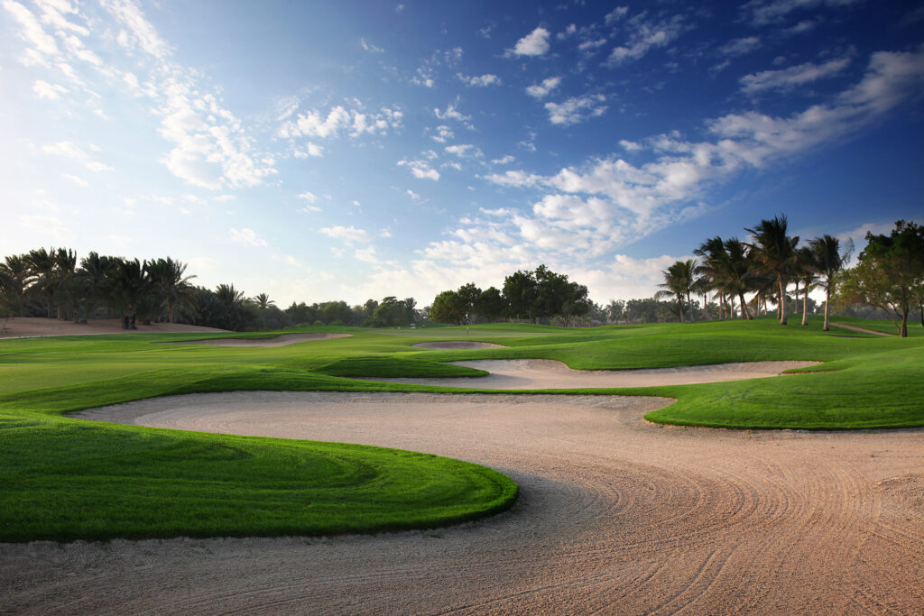 Bunkers on fairway at Abu Dhabi Golf Club - National with trees in background