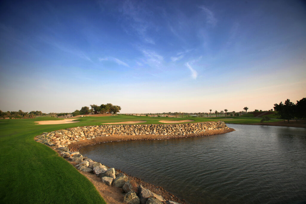 Lake next to fairway with bunkers at Abu Dhabi Golf Club - National