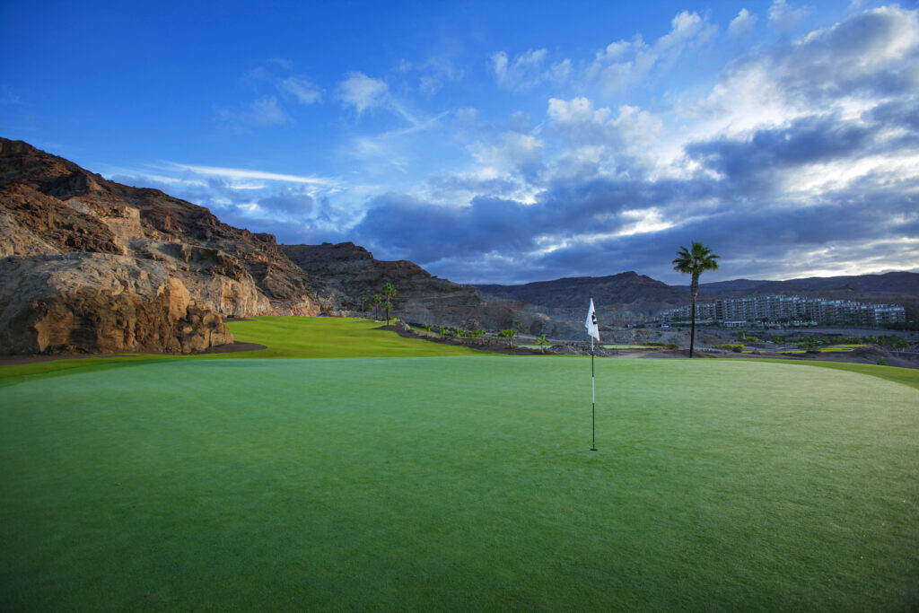 Hole with hillside and building in distance at Anfi Tauro